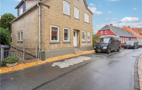 a van parked in front of a brick building at Amazing Apartment In Sønderborg in Sønderborg