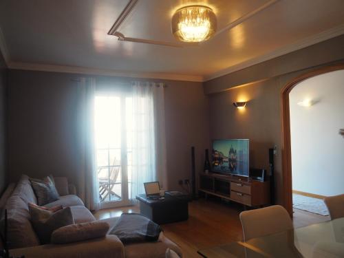 a living room with a couch and a television at Camacho Residence in Funchal