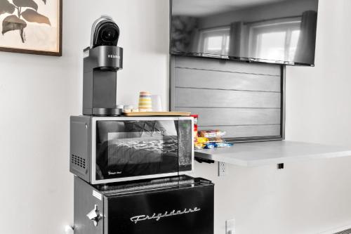 a television sitting on top of a microwave at Green Harbor Hotel in Marshfield
