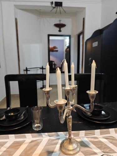 a dining room table with candles on a black table at SOLS Backyard in Arambol