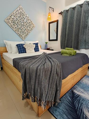 a bedroom with a bed with a blanket on it at SOLS Backyard in Arambol