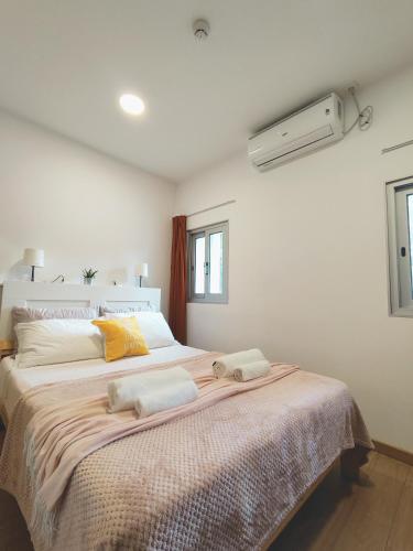a bedroom with a large bed with two towels on it at Get Cozy in Porto