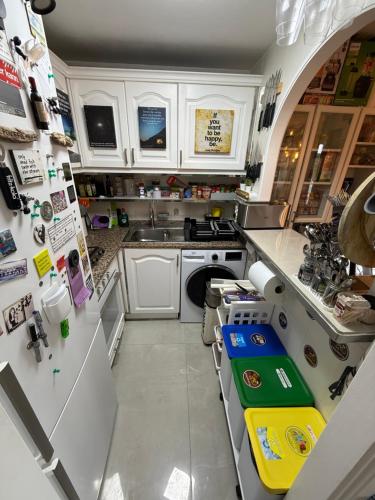 a small kitchen with white cabinets and a sink at FLAT Surrounded by Nature WIFI & Pool & beach Nearby in Son Parc