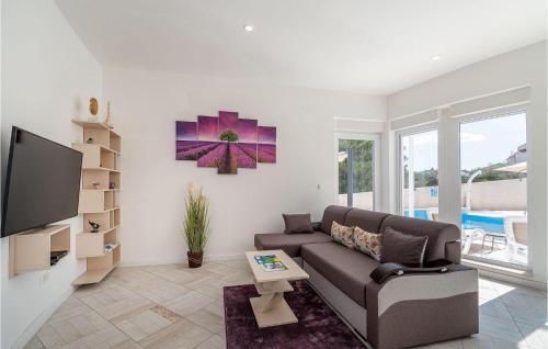 a living room with a couch and a tv at Feriatum Lissa in Zadar