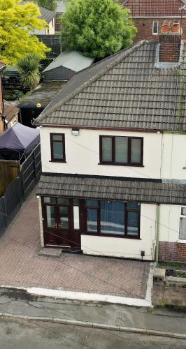 an aerial view of a white house with a roof at LuxuryInn in Wolverhampton
