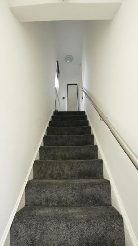a stairway in a building with a stair case at LuxuryInn in Wolverhampton