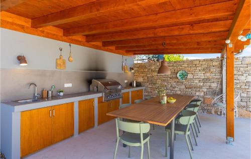 an outdoor kitchen with a wooden table and chairs at Villa Casa Juno in Poreč