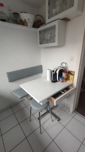 a white table and a chair in a kitchen at Small Double Room, bed 140x200cm, in very quiet and cosy house! in Dübendorf