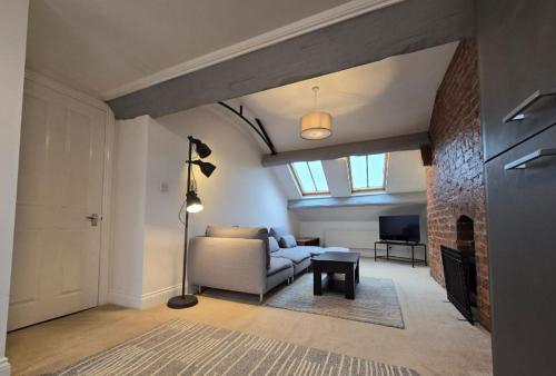a living room with a couch and a fireplace at Stylish City Centre Apartment with Parking in Preston