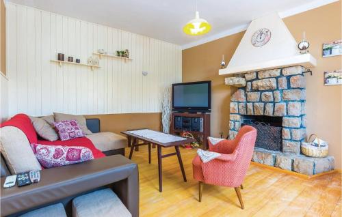 a living room with a couch and a fireplace at Lovely Home In Bribir in Bribir