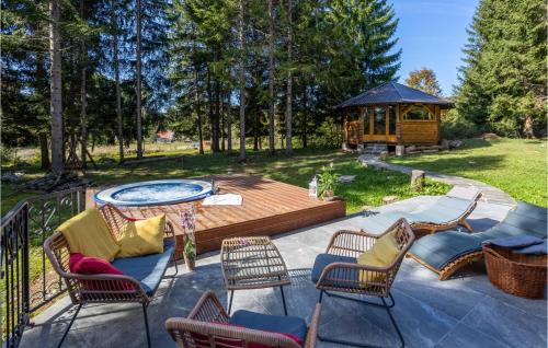a patio with chairs and a table and a gazebo at Stunning Home In Mrkopalj With Sauna in Mrkopalj