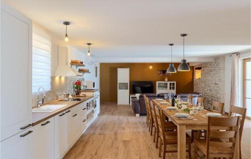 a kitchen and living room with a table and a dining room at Villa Lanca in Poreč