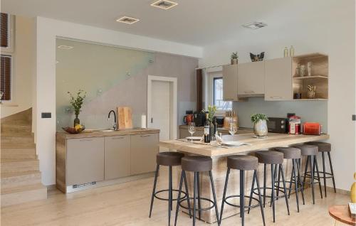 a kitchen with a counter and bar stools at Villa Pervan in Pula