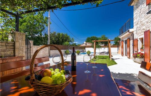 a basket of fruit on a table with wine glasses at Villa Ivka in Pula