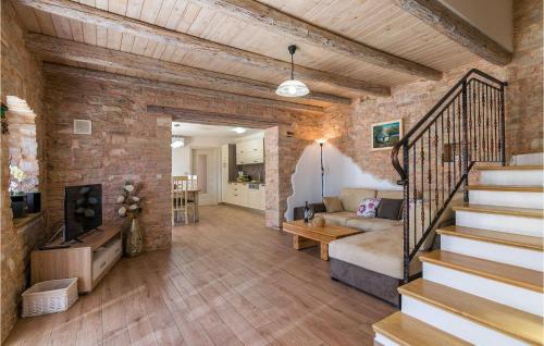 a living room with a staircase and a brick wall at Villa Ivka in Pula