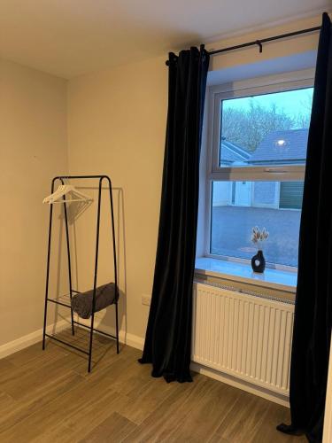 a room with a ladder in front of a window at Cloyfin Holiday Home in Cloyfin
