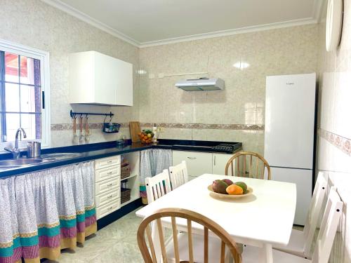 a kitchen with a table with a bowl of fruit on it at Casa La Alpispa in Frontera