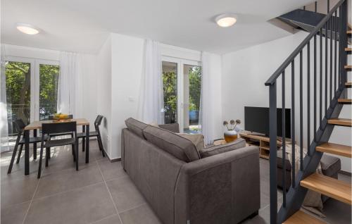 a living room with a couch and a table at Nice Home In Kraljevica With Wifi in Kraljevica
