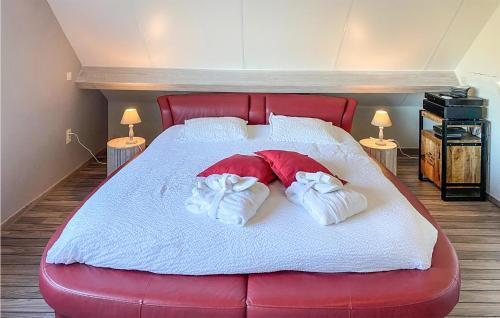 a large red bed with two towels on it at Awesome Home In Diksmuide With Wifi in Diksmuide