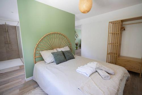 a bedroom with a bed with towels on it at NUXIA Suites&SPA L'Abohème Chic in Bagnols-sur-Cèze