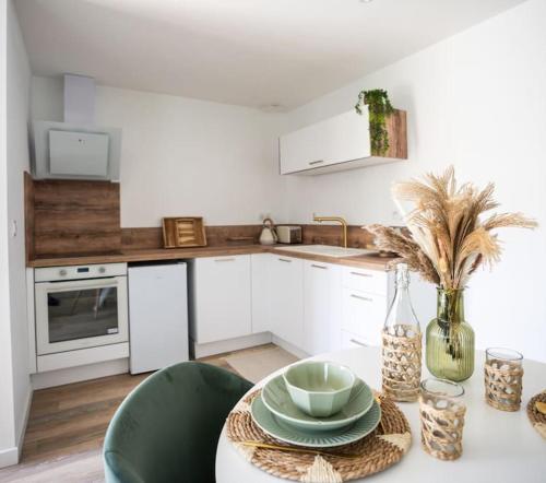 a kitchen with a table with a bowl on it at NUXIA Suites&SPA L'Abohème Chic in Bagnols-sur-Cèze