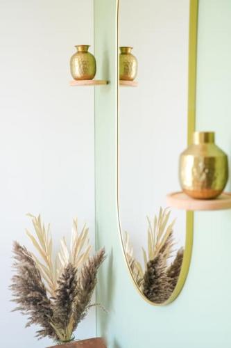 a mirror with a bunch of feathers on a wall at NUXIA Suites&SPA L'Abohème Chic in Bagnols-sur-Cèze