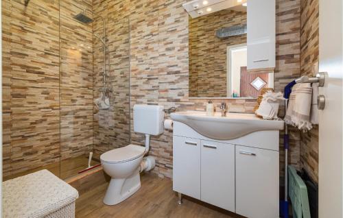 a bathroom with a sink and a toilet and a shower at Lovely Apartment In Maslenica in Maslenica