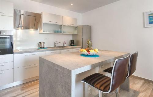 a kitchen with a counter with a bowl of fruit on it at Villa Miceli in Pula