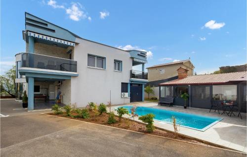 a house with a swimming pool in front of it at 1 Bedroom Awesome Apartment In Vrh in Vrh