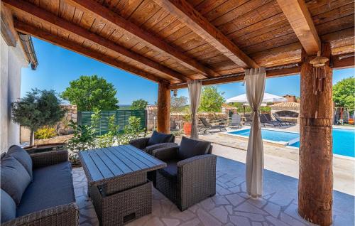 a patio with a table and chairs and a pool at Villa Kunta in Zadar