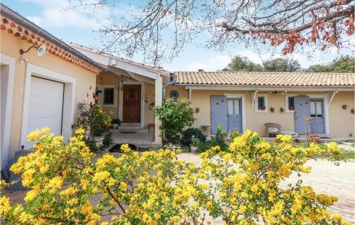 a house with a porch and a garage at Nice Home In Venasque With Kitchen in Venasque