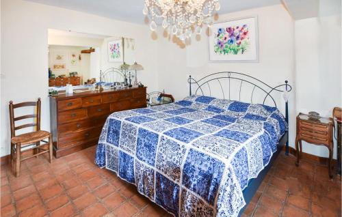 a bedroom with a bed and a dresser and a mirror at Nice Home In Venasque With Kitchen in Venasque