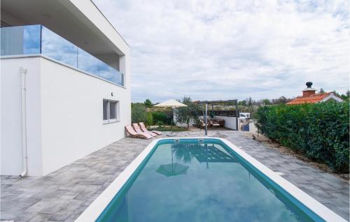 a swimming pool in the backyard of a house at Cld688, Villa Vlahov I in Šibenik