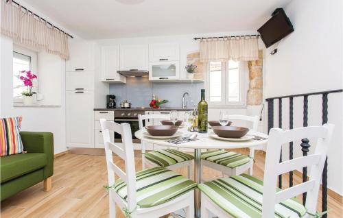 a kitchen and dining room with a table and chairs at 1 Bedroom Nice Apartment In Vrbnik in Vrbnik