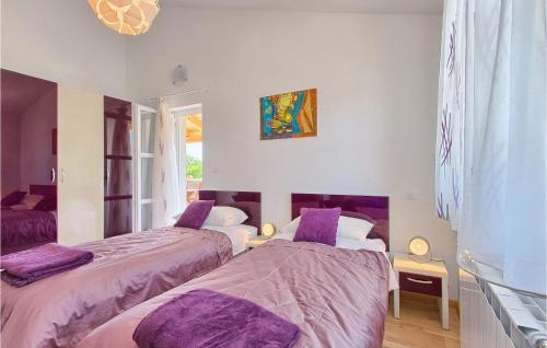 two beds in a room with purple sheets at Villa Bella in Hreljići