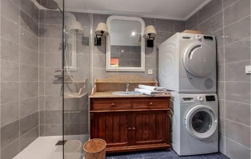a bathroom with a washing machine and a sink at Amazing Home In Thierville in Thierville