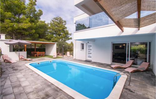 a swimming pool in the backyard of a house at Villa Vlahov Ii in Šibenik