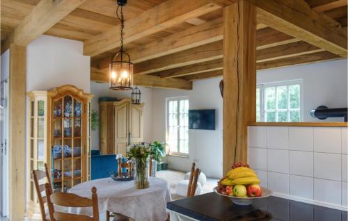 a kitchen with wooden ceilings and a table with a bowl of fruit at Awesome Home In Warendorf With Wifi in Warendorf