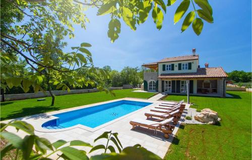 a house with a swimming pool in front of a yard at Villa Bella in Hreljići