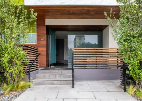 a house with a wooden bench in front of it at SIRTAJ – Beverly Hills in Los Angeles