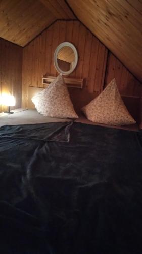 a bedroom with a bed with pillows in a attic at 100 Stufen über dem Rhein in Oberwesel