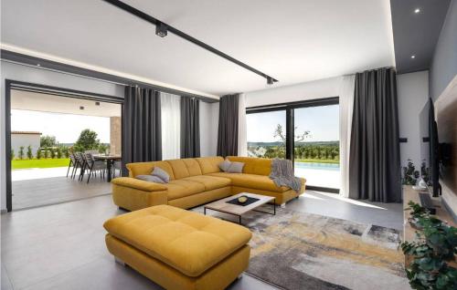 a living room with a yellow couch and a table at Villa Angelina in Gračišće