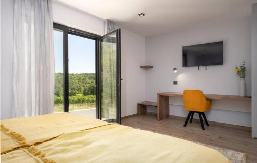 a bedroom with a bed and a desk and a television at Villa Angelina in Gračišće