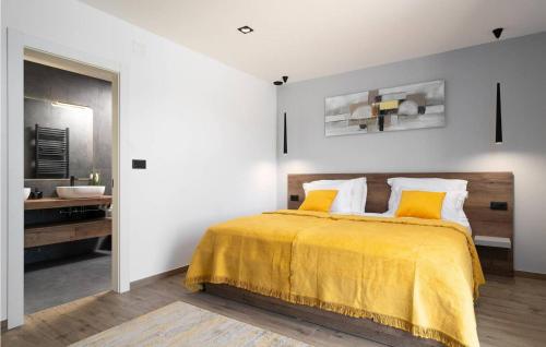 a bedroom with a bed with a yellow blanket at Villa Angelina in Gračišće