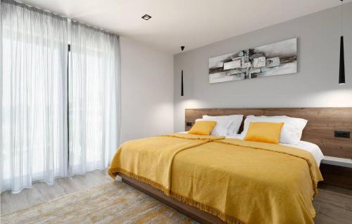 a bedroom with a large bed with yellow sheets at Villa Angelina in Gračišće