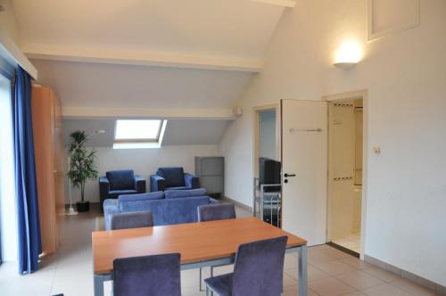 a dining room with chairs and a table and a room at Résidence Durbuy in Durbuy
