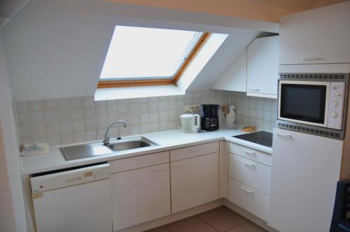 a small kitchen with a sink and a window at Résidence Durbuy in Durbuy