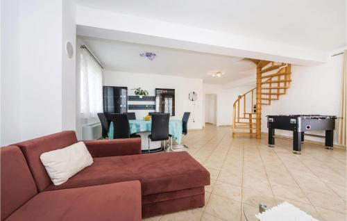 a living room with a couch and a table at 3 Bedroom Lovely Home In Novalja in Novalja