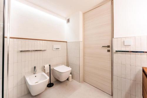a bathroom with a toilet and a sink at Nel Blu Dipinto Di Blu in Simius