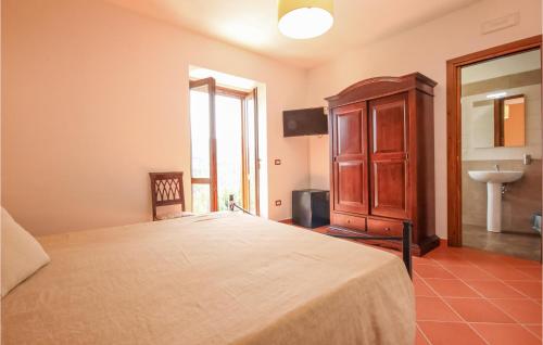 a bedroom with a large bed and a sink at Lovely Home In Rutino With Kitchen in Rutino